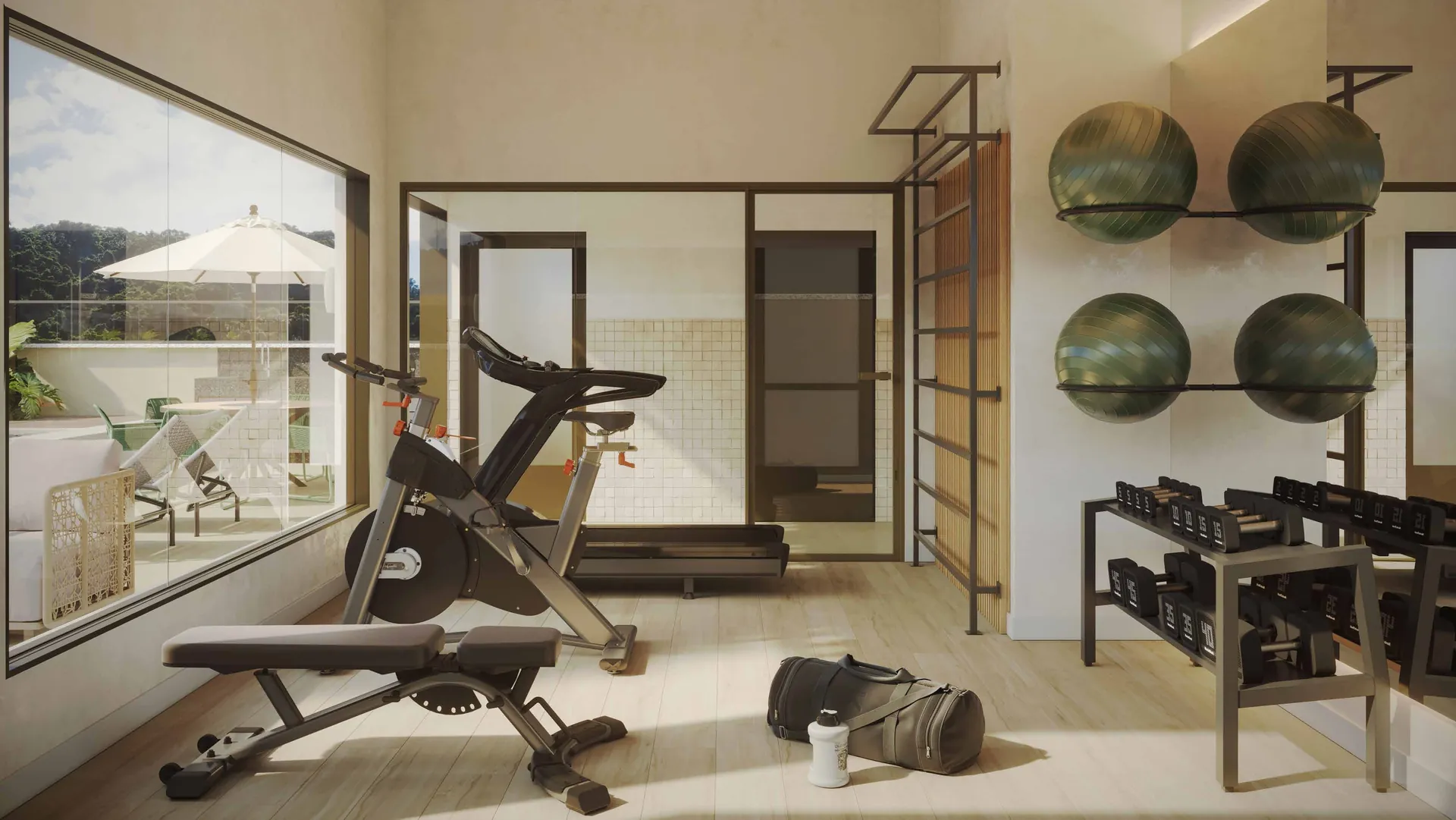 Academia com bicicleta, bolas de pilates e janela ampla