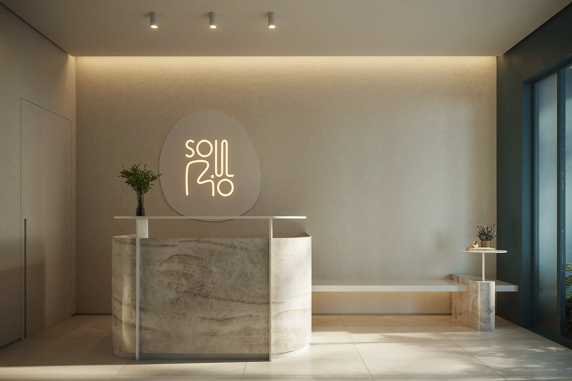 Recepção com balcão de pedra e o logo do Soul Rio